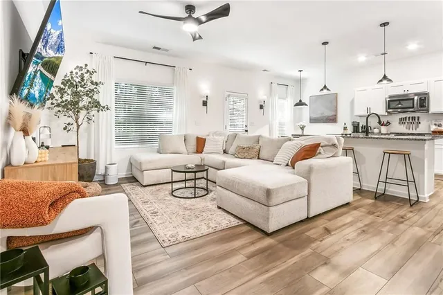 a living room with furniture and a large window