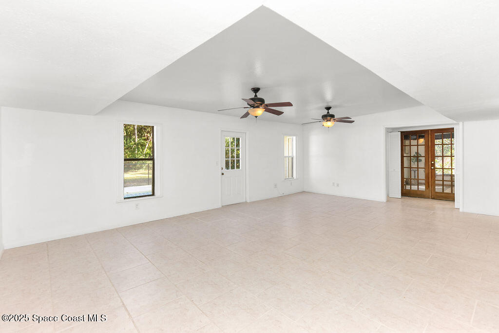 2524 Trotters Trail Cocoa, FL 32926 - Photo 12 of 46 an empty room with windows and ceiling fan