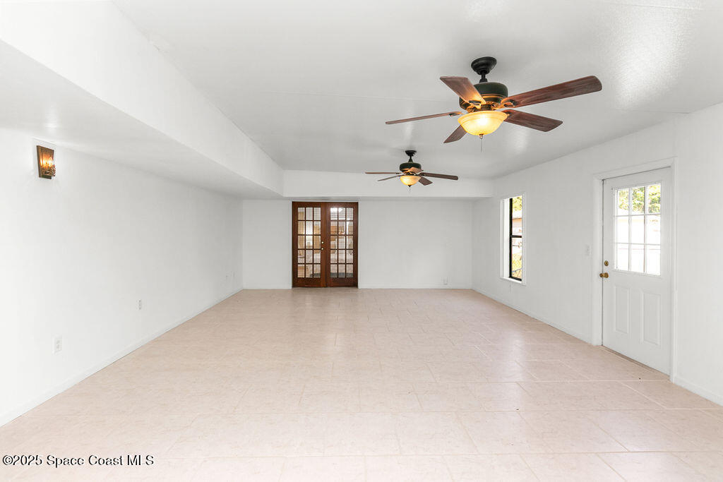 2524 Trotters Trail Cocoa, FL 32926 - Photo 13 of 46 a view of a livingroom with a ceiling fan and window