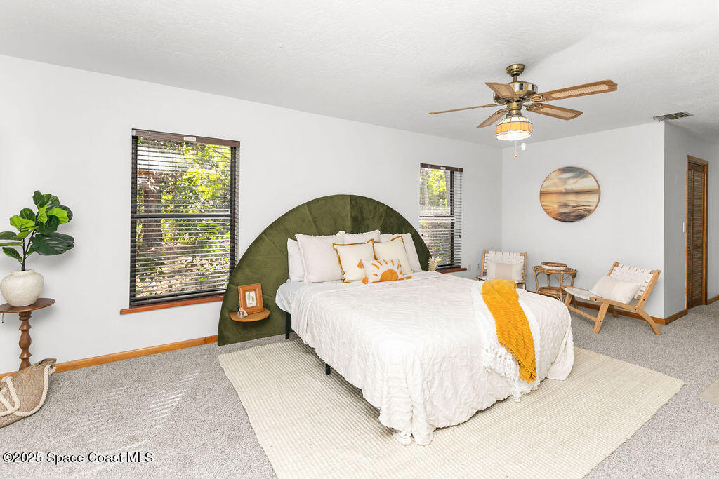 2524 Trotters Trail Cocoa, FL 32926 - Photo 16 of 46 a bedroom with a bed and a chandelier
