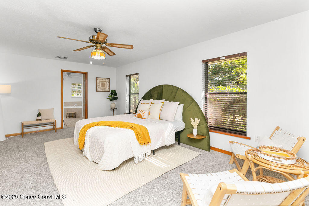 2524 Trotters Trail Cocoa, FL 32926 - Photo 17 of 46 a bedroom with a bed and a chandelier