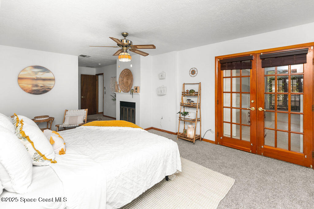 2524 Trotters Trail Cocoa, FL 32926 - Photo 18 of 46 a bedroom with a bed and a chandelier