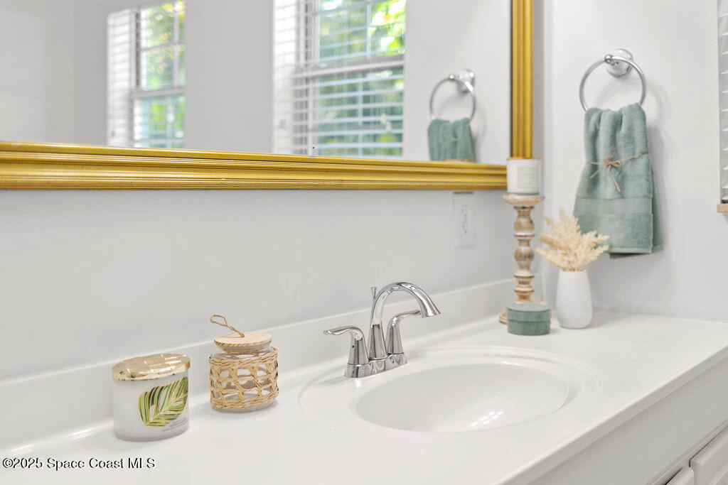 2524 Trotters Trail Cocoa, FL 32926 - Photo 22 of 46 a bathroom with a sink and a mirror