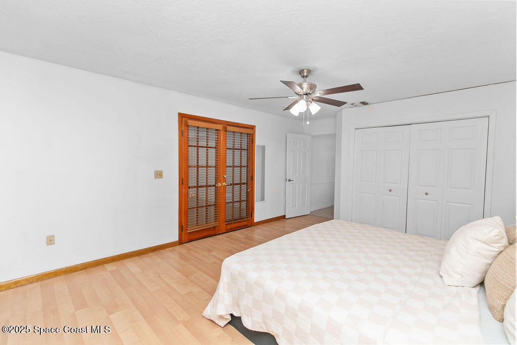 2524 Trotters Trail Cocoa, FL 32926 - Photo 27 of 46 a bedroom with a large bed window and a ceiling fan