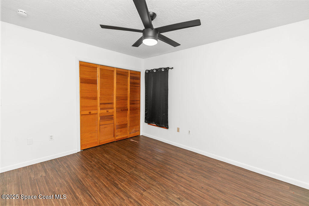 2524 Trotters Trail Cocoa, FL 32926 - Photo 30 of 46 an empty room with wooden floor and windows