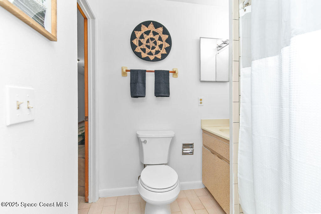 2524 Trotters Trail Cocoa, FL 32926 - Photo 31 of 46 a bathroom with a toilet and a shower curtain