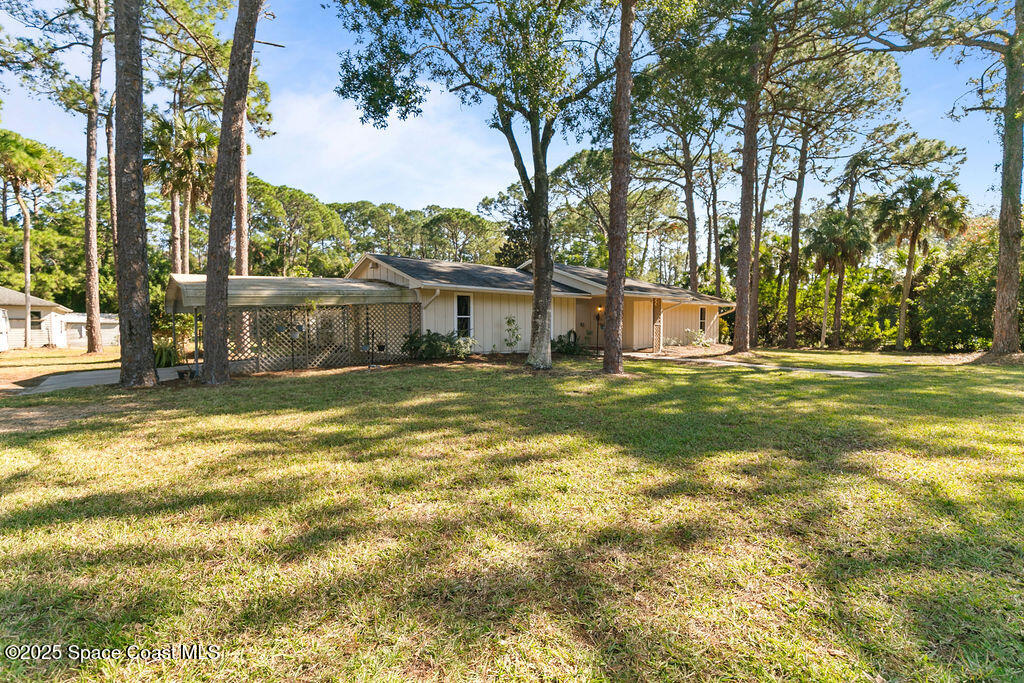 2524 Trotters Trail Cocoa, FL 32926 - Photo 41 of 46 a view of a house with a big yard and large trees