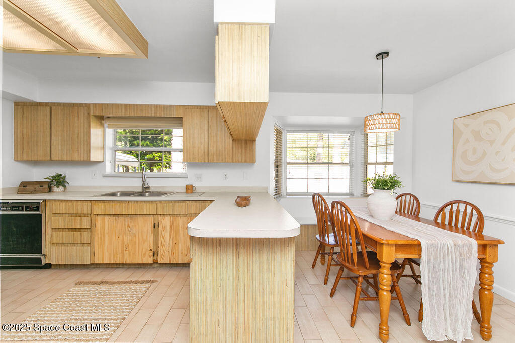 2524 Trotters Trail Cocoa, FL 32926 - Photo 6 of 46 a kitchen with stainless steel appliances granite countertop a sink a stove a dining table and chairs