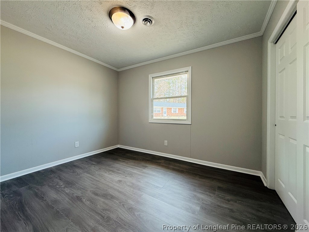 4730 Rosehill Road, Unit 4736 Fayetteville, NC 28311 - Photo 12 of 15 an empty room with wooden floor and windows