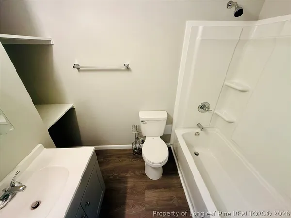 a bathroom with a toilet and a bathtub