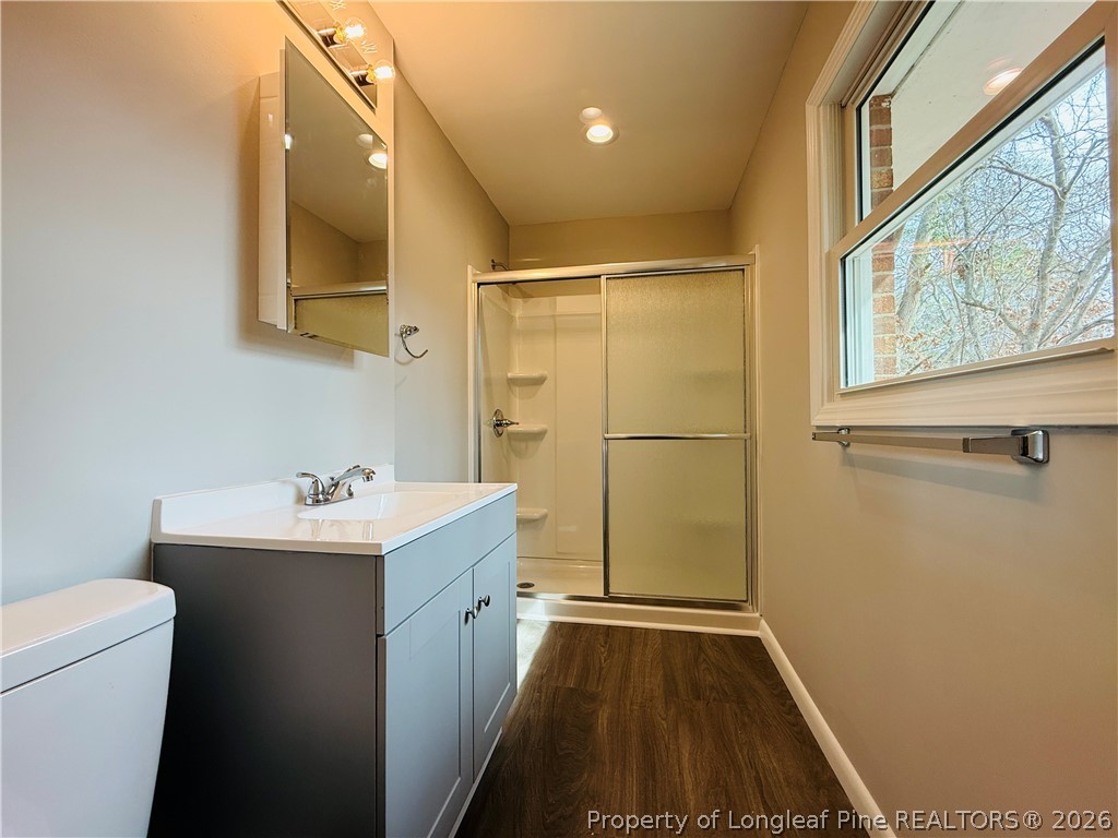 4730 Rosehill Road, Unit 4736 Fayetteville, NC 28311 - Photo 9 of 15 a bathroom with a sink a toilet a mirror and shower