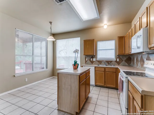 a kitchen with stainless steel appliances granite countertop a sink and a stove