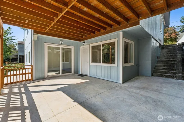 a view of a porch with wooden floor and iron stairs