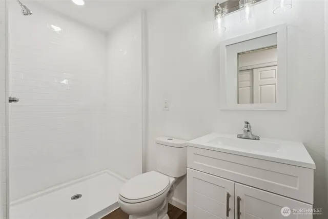 a bathroom with a sink toilet and shower