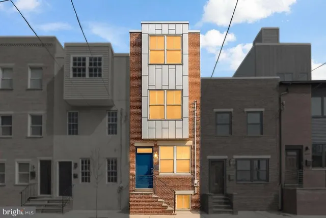 a front view of a house with large windows