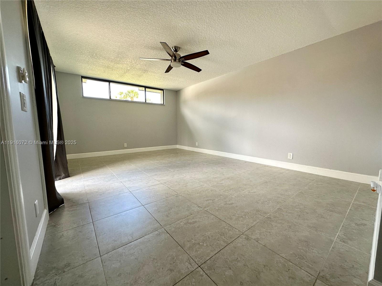 22970 Oxford Place, Unit A Boca Raton, FL 33433 - Photo 11 of 24 an empty room with windows and entrance