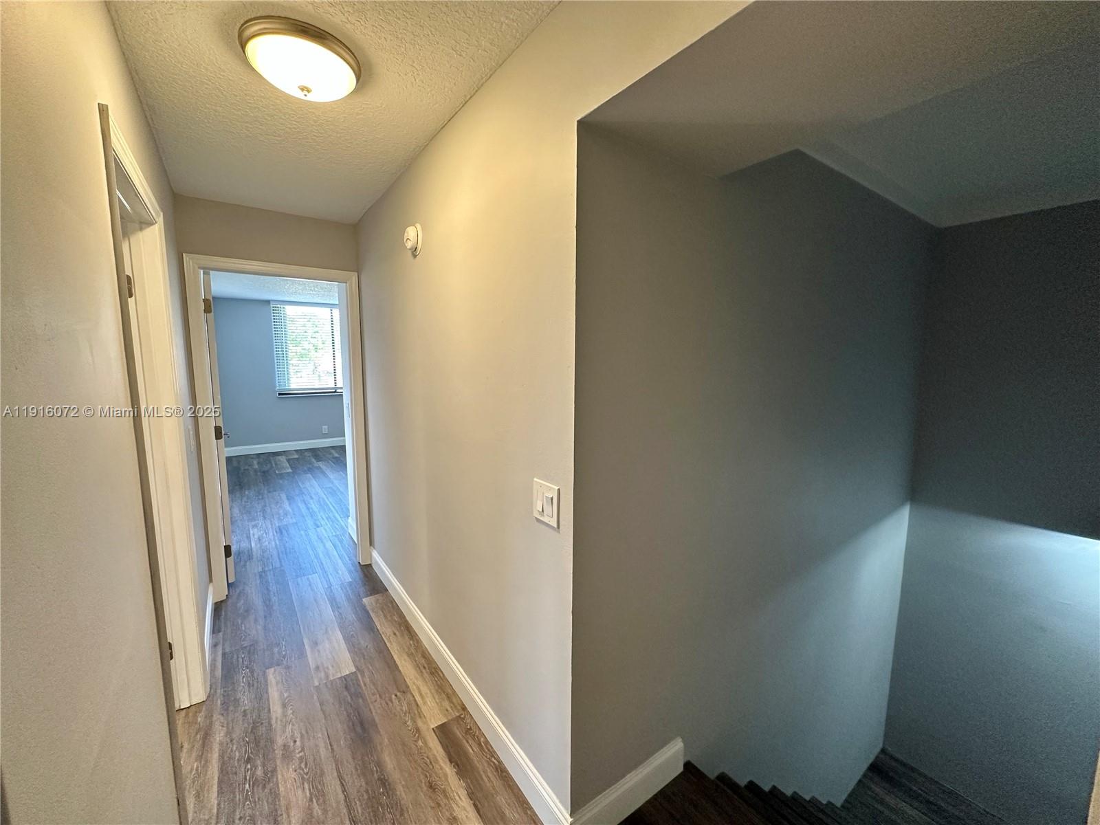 22970 Oxford Place, Unit A Boca Raton, FL 33433 - Photo 12 of 24 a view of hallway with wooden floor