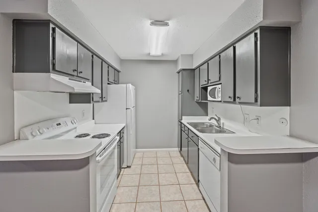 a kitchen with stainless steel appliances a sink stove and cabinets