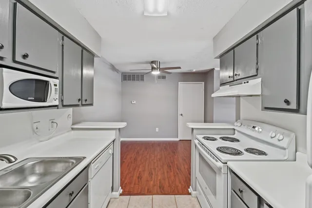a kitchen that has a sink and a stove