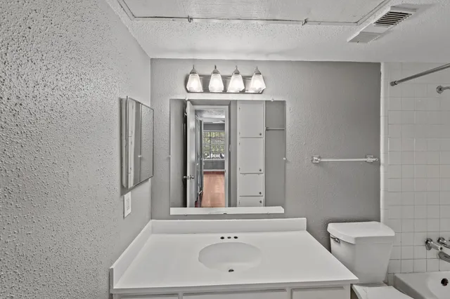 a bathroom with a bathtub and a sink