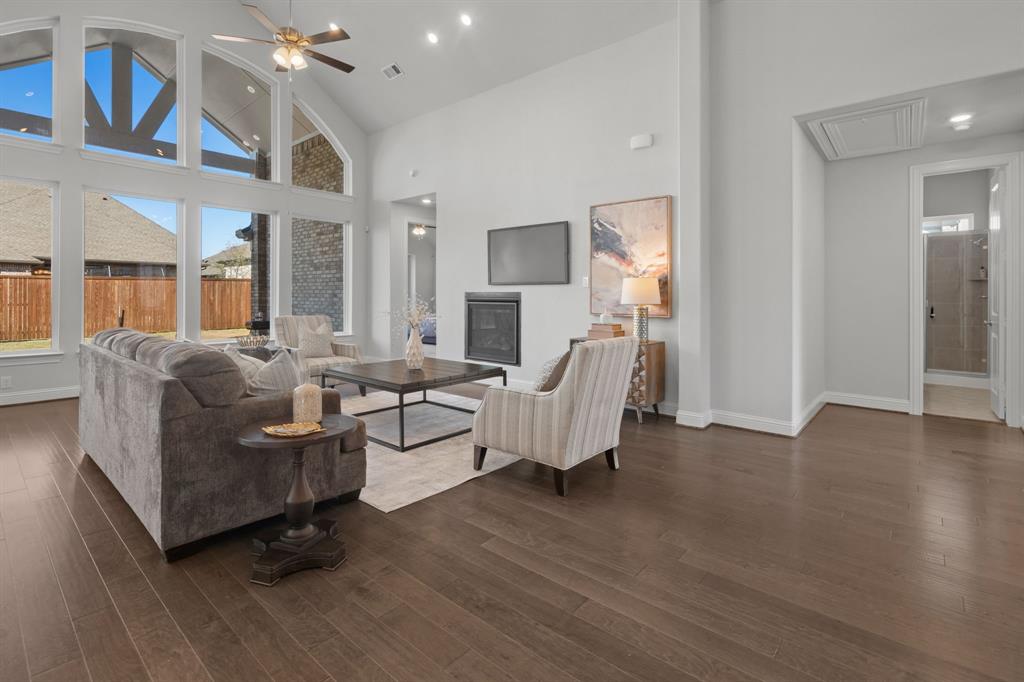 1320 Cartona Road Fate, TX 75087 - Photo 6 of 35 Vaulted Cathedral Style ceiling, Luxury vinyl wood-finish flooring, built-in fireplace, and recessed lighting