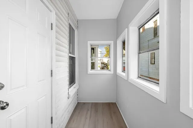 a view of an entryway with wooden floor and windows