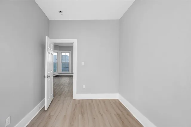 a view of wooden floor and windows in a room