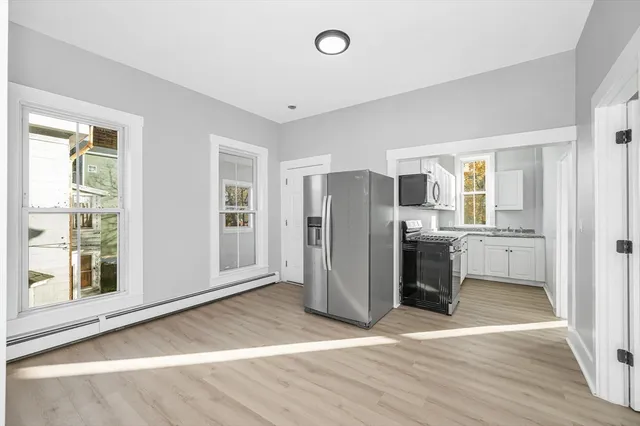 a view of a kitchen with a refrigerator cabinets and a window