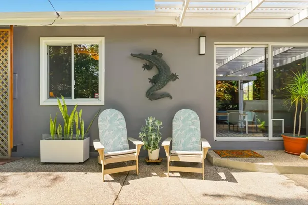 a view of a house with backyard sitting area and garden