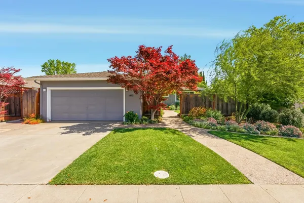 a front view of a house with a yard and a garage