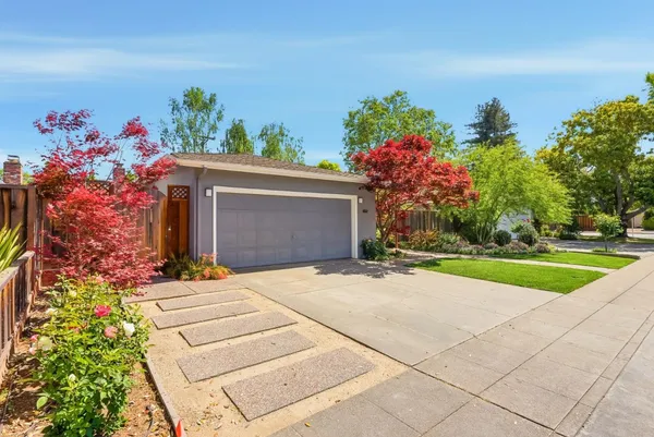 a front view of a house with a yard and a garage