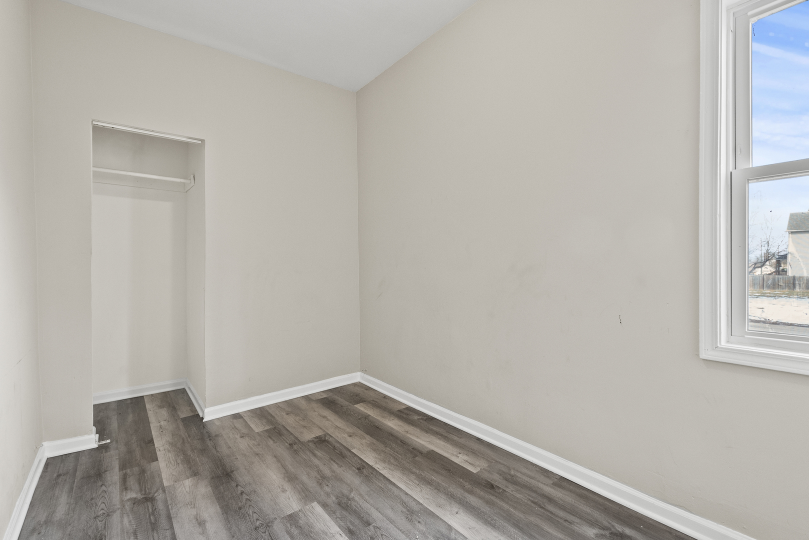 503 West 81st Street Chicago, IL 60620 - Photo 12 of 29 a view of a room that has wooden floor and a window
