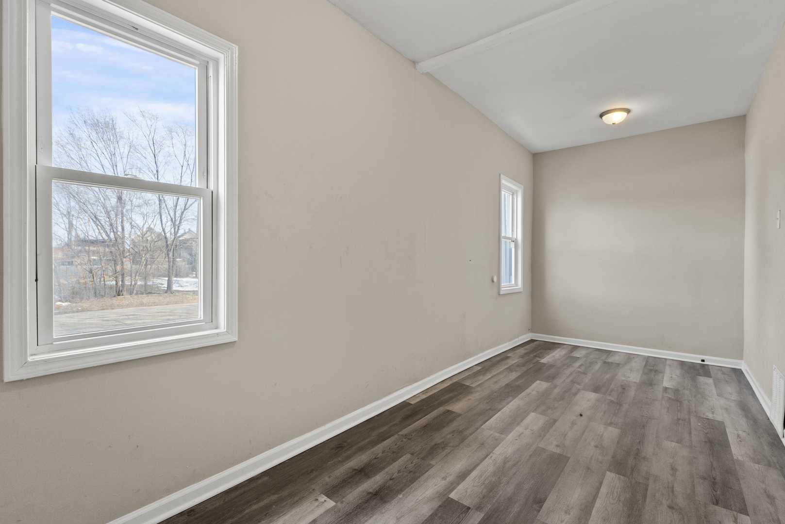 503 West 81st Street Chicago, IL 60620 - Photo 14 of 29 an empty room with wooden floor and windows