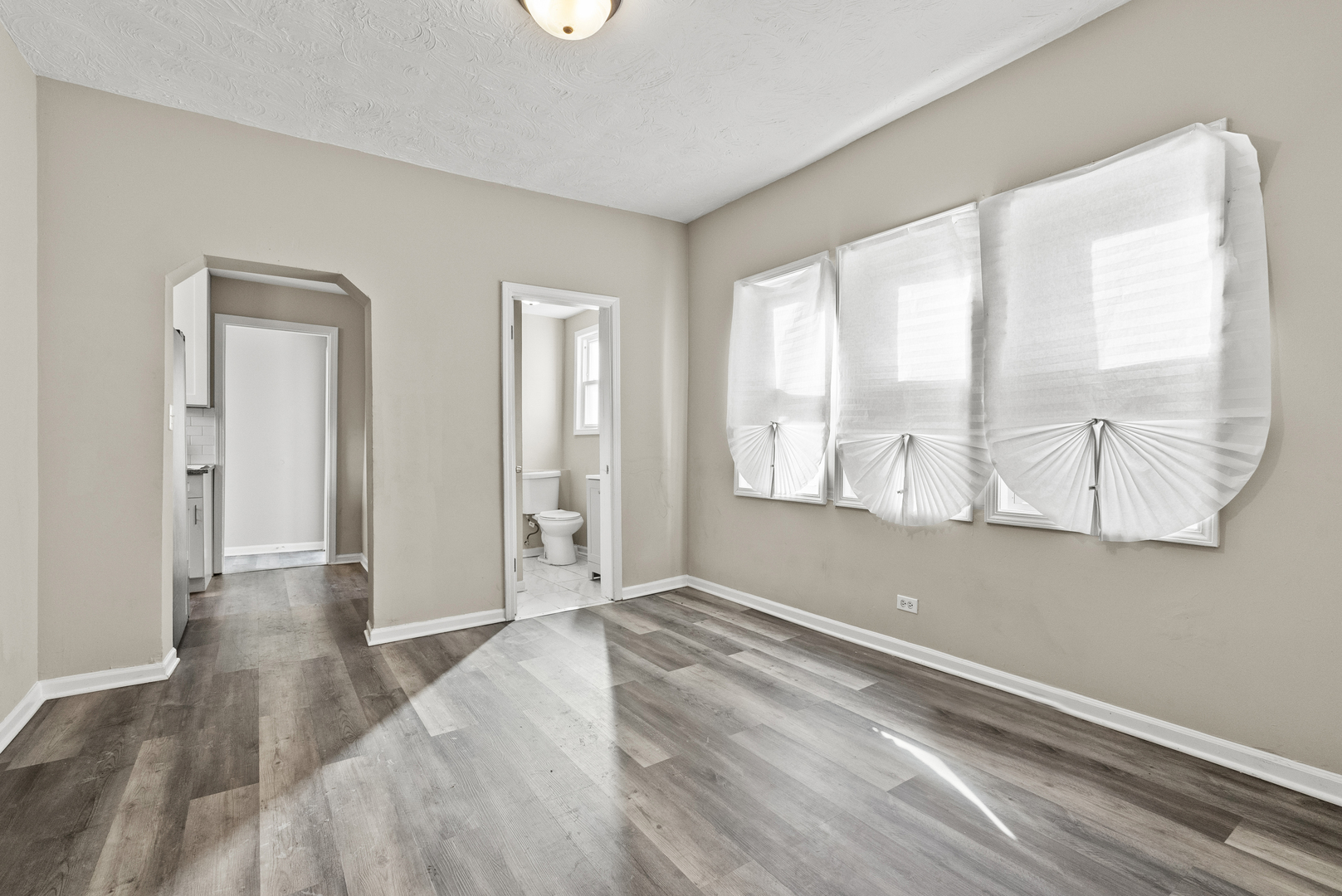 503 West 81st Street Chicago, IL 60620 - Photo 15 of 29 an empty room with wooden floor and windows