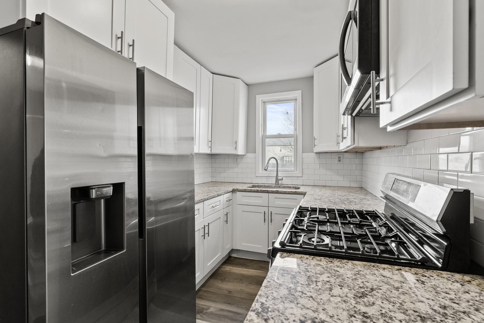 503 West 81st Street Chicago, IL 60620 - Photo 4 of 29 a kitchen with stainless steel appliances granite countertop a refrigerator a sink and white cabinets