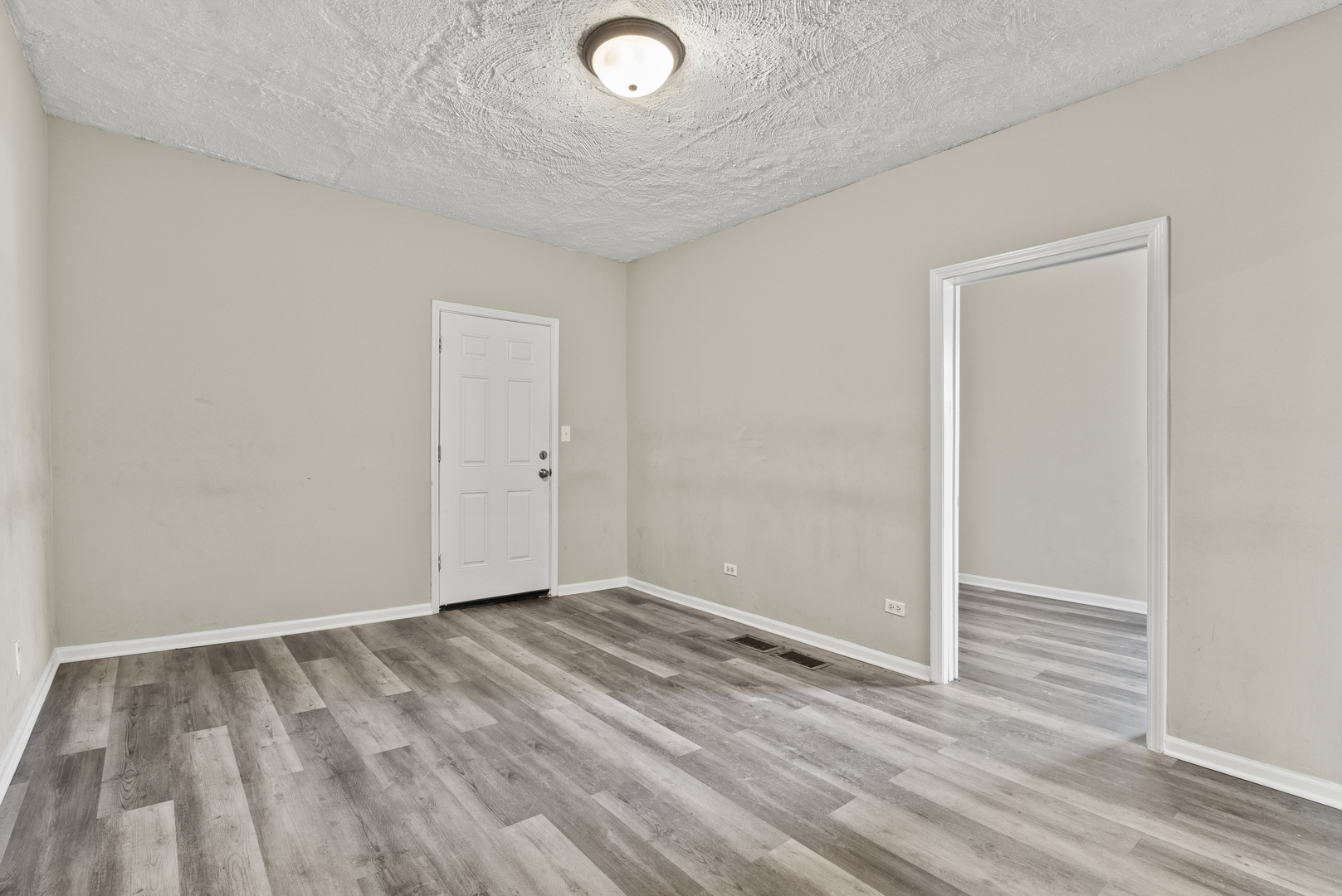 503 West 81st Street Chicago, IL 60620 - Photo 7 of 29 an empty room with wooden floor and windows
