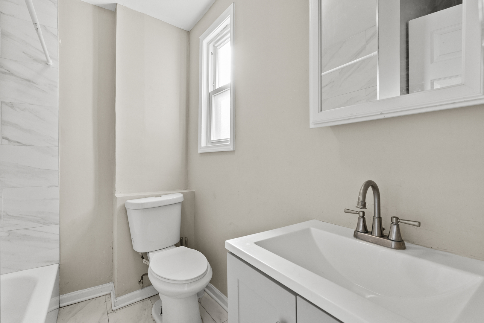 503 West 81st Street Chicago, IL 60620 - Photo 9 of 29 a bathroom with a toilet sink and mirror