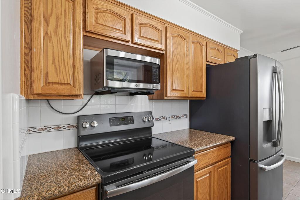 2418 Lexington Drive Ventura, CA 93003 - Photo 12 of 36 a kitchen with stainless steel appliances granite countertop a refrigerator stove and microwave