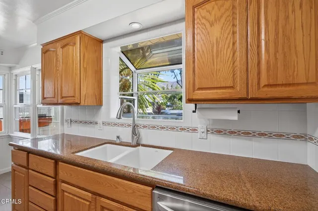 an empty room with windows closet and chandelier fan