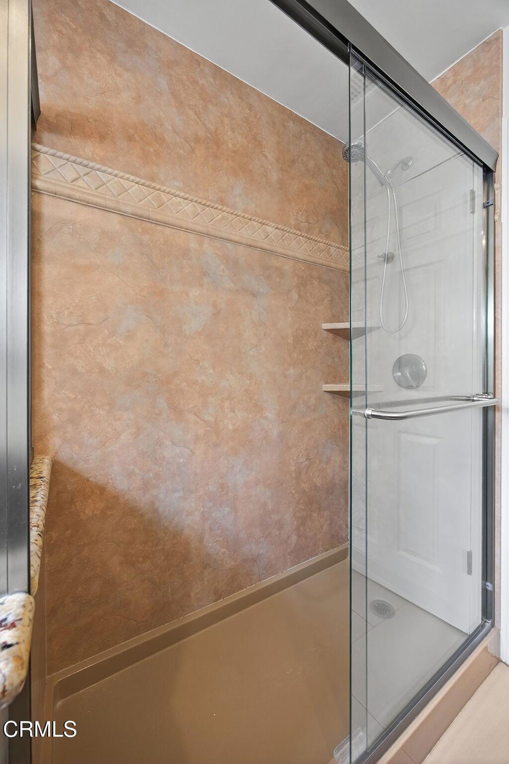 2418 Lexington Drive Ventura, CA 93003 - Photo 23 of 36 a bathroom with a glass shower door