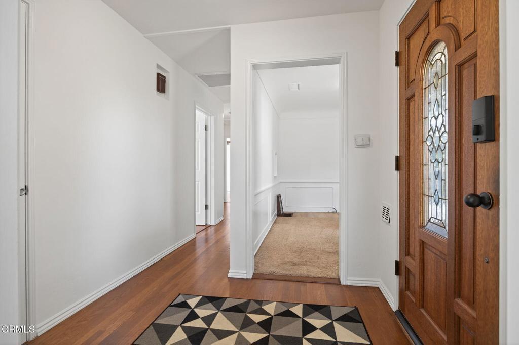 2418 Lexington Drive Ventura, CA 93003 - Photo 6 of 36 a view of a hallway with wooden floor and a bathroom