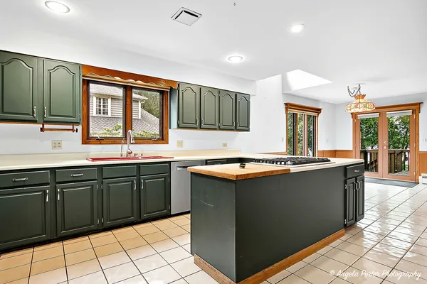 a kitchen with stainless steel appliances granite countertop a sink and cabinets