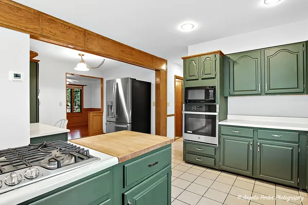 a kitchen with stainless steel appliances kitchen island a sink stove and refrigerator