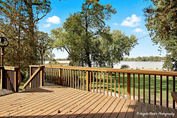 a balcony with wooden floor and fence