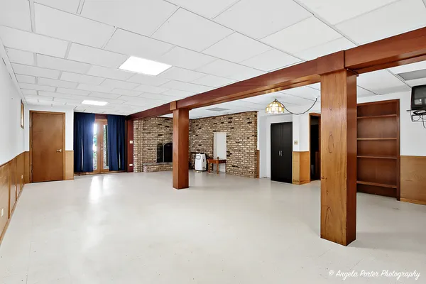 a view of an empty room with window and cabinet
