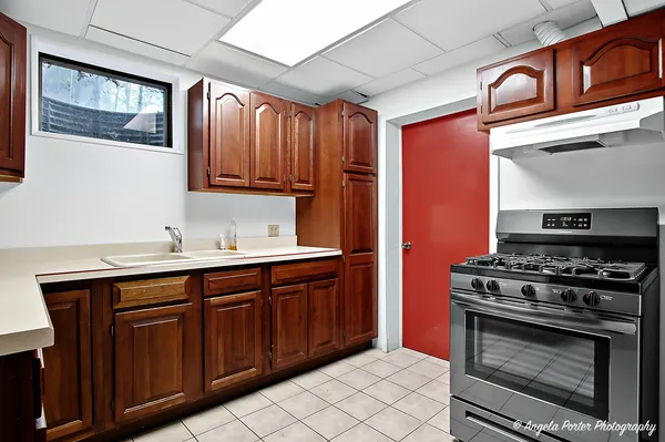 a kitchen with stainless steel appliances a stove a sink and a microwave