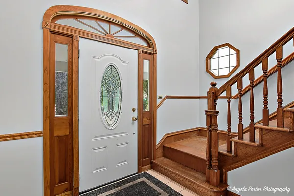 a view of an entryway with wooden floor