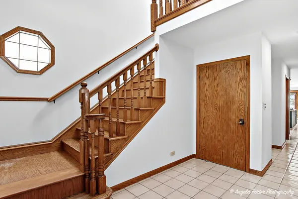a view of an entryway with wooden floor and stairs
