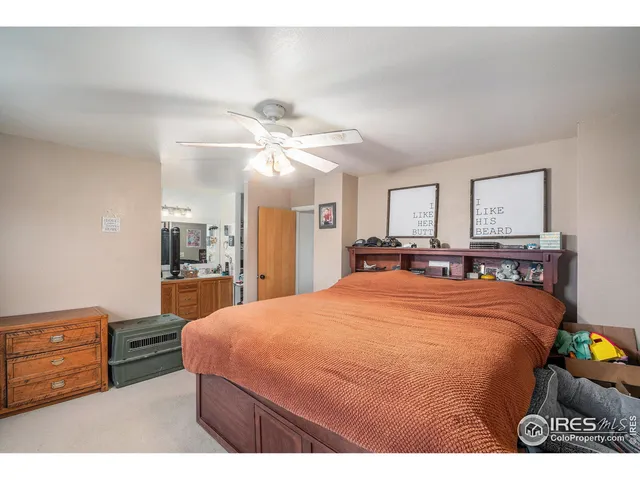 a bed room with a bed mirror and a dresser