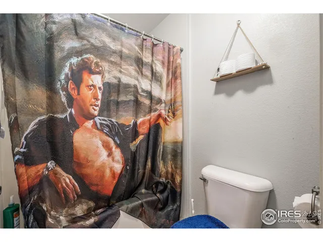 a bathroom with a toilet and a mirror